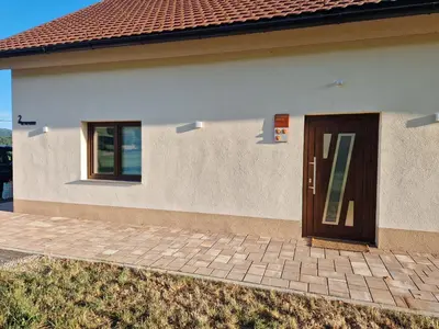 a house with a brown door on the side at Linden Retreat Apartments with Sauna in Spodnje Mestinje