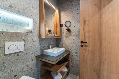 a bathroom with a sink and a mirror at Gora Luxury Apartments in Kranjska Gora