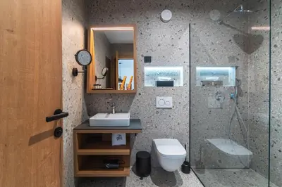 a bathroom with a shower and a toilet and a sink at Gora Luxury Apartments in Kranjska Gora