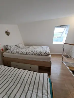 a bedroom with two beds and a window at Apartma Misha in Bovec