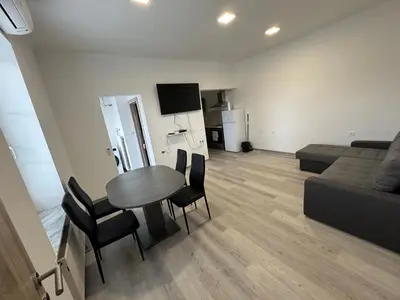a living room with a table and chairs and a couch at Jack apartments in Maribor