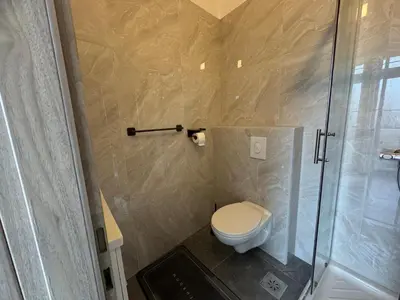 a bathroom with a toilet and a shower at Jack apartments in Maribor