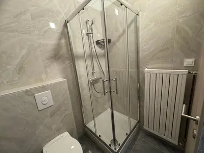 a shower stall in a bathroom with a toilet at Jack apartments in Maribor