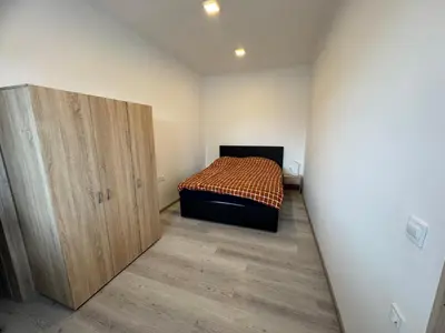 a bedroom with a bed and a wooden cabinet at Jack apartments in Maribor
