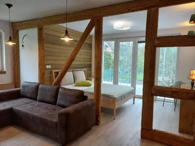 a living room with a couch and a bed at apartma Aljaž in Spodnja Idrija