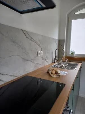 a kitchen with a counter with a sink and a window at apartma Aljaž in Spodnja Idrija