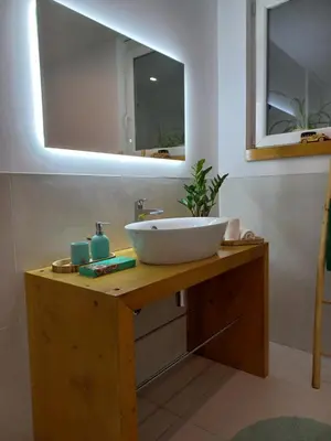 a bathroom with a sink and a mirror at apartma Aljaž in Spodnja Idrija