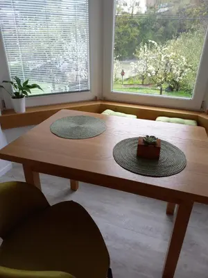 a wooden table with two hats on top of it at apartma Aljaž in Spodnja Idrija
