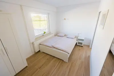 a small bedroom with a bed and a window at Apartma Tom in Metlika