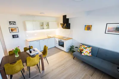 a living room with a couch and a table at Apartma Tom in Metlika