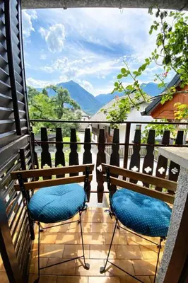 two chairs on a balcony with a view of mountains at Holiday Home Kristi in Bovec