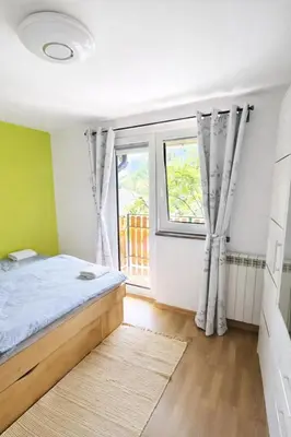 a bedroom with a bed and a window at Holiday Home Kristi in Bovec