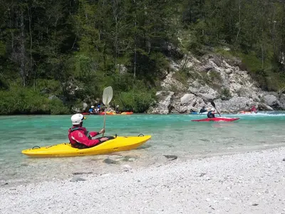 a person in a yellow kayak in the water at Holiday Home Kristi in Bovec