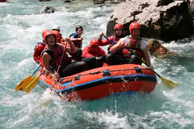 a group of people in a raft in a river at Holiday Home Kristi in Bovec