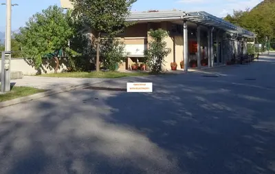 a street with a sign in front of a building at Kamp Tura- camping pitch only in Vipava