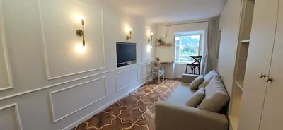 a living room with a couch and a television at Apartment Econte near old town in Ljubljana