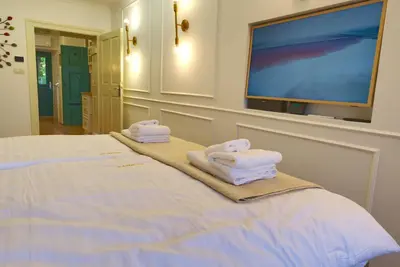 a bedroom with a bed with towels and a flat screen tv at Apartment Econte near old town in Ljubljana