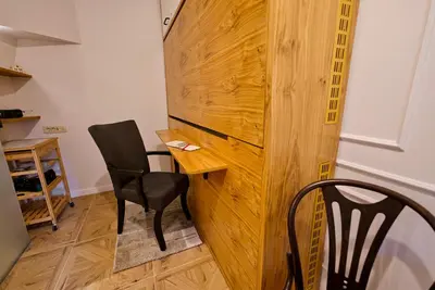 a room with two chairs and a wooden wall at Apartment Econte near old town in Ljubljana