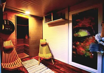 two chairs sitting on the porch of a house at Mobile Home Cabana with HotTub&Sauna in Spodnja Polskava