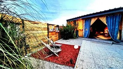 a patio with two chairs sitting on a red carpet at Mobile Home Cabana with HotTub&Sauna in Spodnja Polskava
