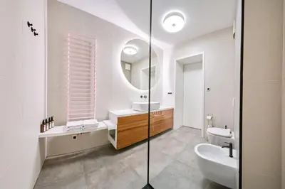 a bathroom with a sink and a mirror at Matic Atrium Designer Apartment in Ljubljana