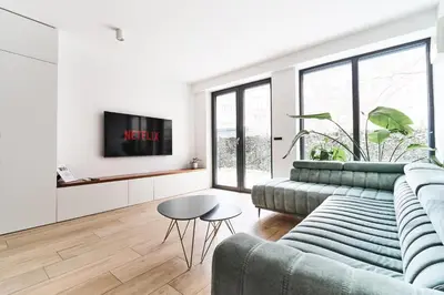 a living room with a couch and a table at Matic Atrium Designer Apartment in Ljubljana