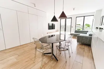 a kitchen and living room with a table and chairs at Matic Atrium Designer Apartment in Ljubljana