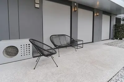 two chairs and a fan sitting on a patio at Matic Atrium Designer Apartment in Ljubljana