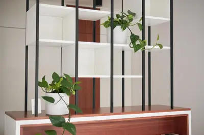 a book shelf with two potted plants on it at Matic Atrium Designer Apartment in Ljubljana