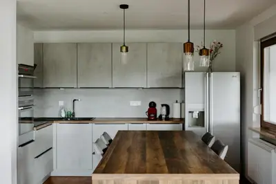 a kitchen with a wooden table and a refrigerator at Inspired by Nature Homestay