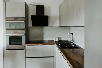 a kitchen with stainless steel appliances and a sink at Inspired by Nature Homestay