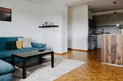 a living room with a blue couch and a coffee table at Inspired by Nature Homestay