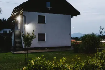 a house with a light on the side of it at Inspired by Nature Homestay