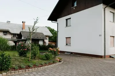 a white house and a house with a driveway at Inspired by Nature Homestay