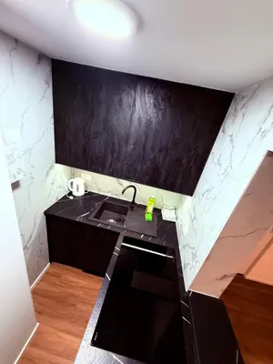 a kitchen with a sink and a black counter top at Resort PJagodic in Cerklje na Gorenjskem