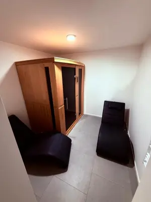 a small room with a chair and a cabinet at Resort PJagodic in Cerklje na Gorenjskem