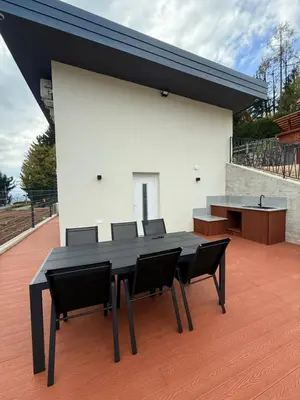 a black dining table and chairs on a patio at Resort PJagodic in Cerklje na Gorenjskem