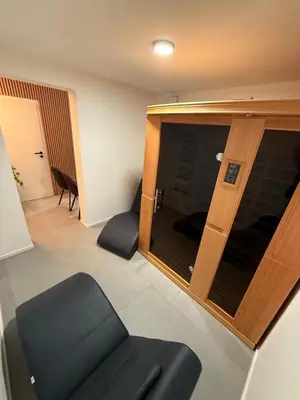 a living room with a couch and a glass door at Resort PJagodic in Cerklje na Gorenjskem