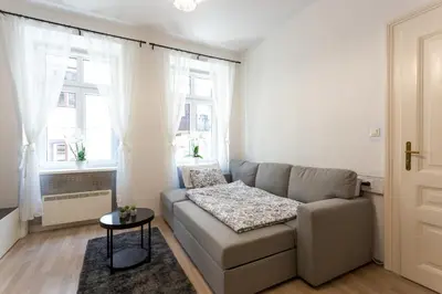 a living room with a couch and a window at Old Town Sixteen in Ljubljana
