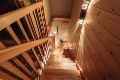 a wooden staircase in a house with a wooden wall at Apartments Krvavec in Cerklje na Gorenjskem