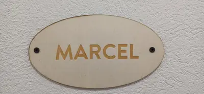 a sign on a wall with the word managed at HIŠA Margit in Rateče