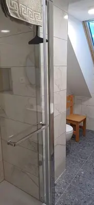a shower with a glass door in a bathroom at HIŠA Margit in Rateče