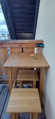 a wooden table and bench in a room at HIŠA Margit in Rateče