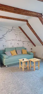 a living room with a blue couch and a table at HIŠA Margit in Rateče