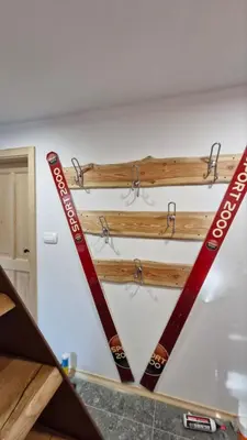 two pairs of skis are hanging on a wall at HIŠA Margit in Rateče