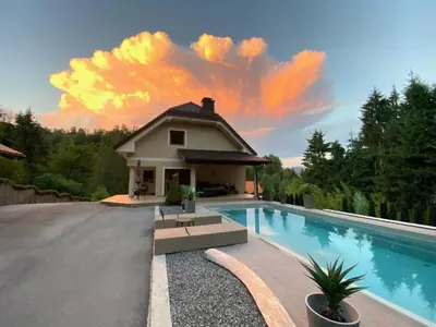 a house with a swimming pool next to a house at Vila Tin & Koča Tin in Prestranek