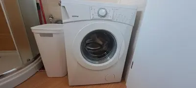 a washing machine sitting next to a trash can at Apartma Moravske Toplice 6 in Moravske Toplice