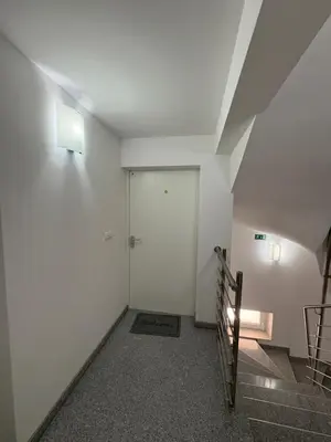 a hallway with a white door and stairs at Apartma Moravske Toplice 6 in Moravske Toplice