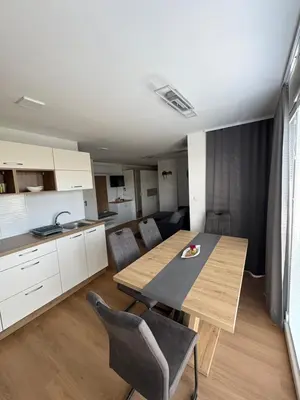 a kitchen and dining room with a table and chairs at Apartma Moravske Toplice 6 in Moravske Toplice