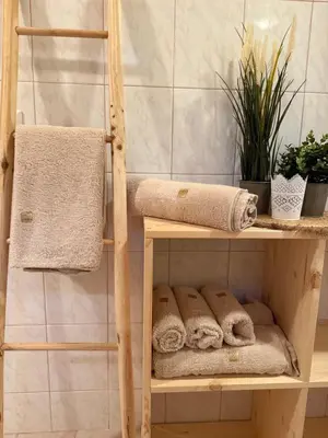 a wooden shelf with towels on it in a bathroom at Katja Cottage in Bohinjska Bela